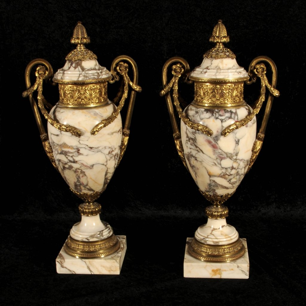 PR. ANTIQUE FRENCH MARBLE COVERED URNS WITH ORMOLU: PR. ANTIQUE FRENCH MARBLE COVERED URNS WITH ORMOLU MOUNTS. WHITE VEINED MARBLE URNS, DOUBLE FLORAL & SCROLL HANDLES WITH FLORAL SWAG DECORATION. ORMOLU & MARBLE BASES. GOOD. 23 1/2" H X 10 1/2'" W.