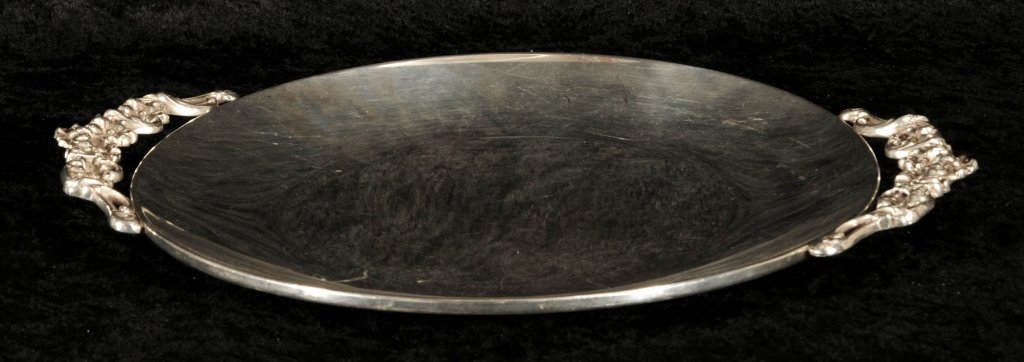 ROUND STERLING SILVER TRAY. FLORAL DESIGN HANDLES.: ROUND STERLING SILVER TRAY. FLORAL DESIGN HANDLES. MARKER B & M. APPROX. 25.25 TROY OZS. GOOD. 1 1/8" H X 15" W X 12" D.