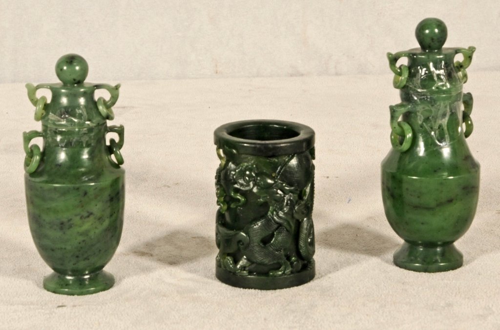 3 CARVED CHINESE JADE PCS. CONSISTING OF 2 URNS WITH: 3 CARVED CHINESE JADE PCS. CONSISTING OF 2 URNS WITH RING HANDLES AND A VASE WITH DRAGON DECORATION. 3 1/4" H X 2 1/8" DIA. GOOD. URN 5" H X 2 1/4" DIA.