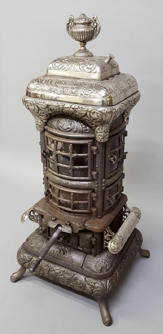 Ornate Cast Iron & Nickel Stove with 6 Mica doors: Ornate Cast Iron & Nickel Stove with 6 Mica doors signed Co-Op Foundry 1897, Rochester NY. model Red Cross Sunbeam l# 45 - Design Pat. Sept 21, 1897. Hgt 49" w 24".Very good restored condition. Found