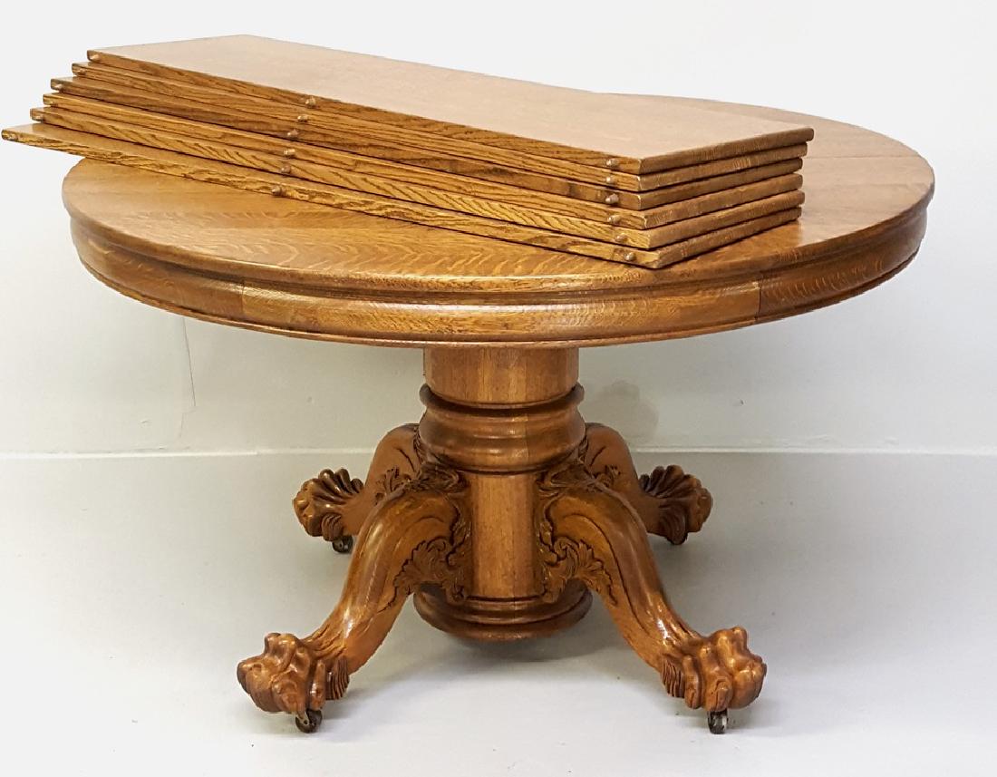 Circa 1900 48" Hastings Co.14 cut Round Oak Table.: Circa 1900 48" Hastings Co.14 cut Round Oak Table. Table is 48" closed. 10 feet with all 6 leaves and fully extended. Solid oak with carving on the legs and well done 5 toe claw foot. Refinished ready