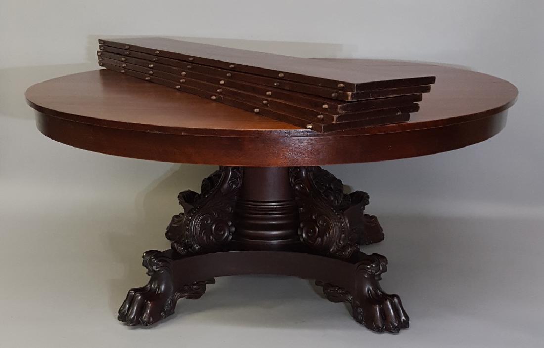 Massive Heavily Carved Round extension Dining Table.: Massive Heavily Carved Round extension Dining Table. 66" Round when closed 10 feet long with all 5 - 12" leaves. Table is solid mahogany made in about 1885. Good cleaned finish. Solid working conditio