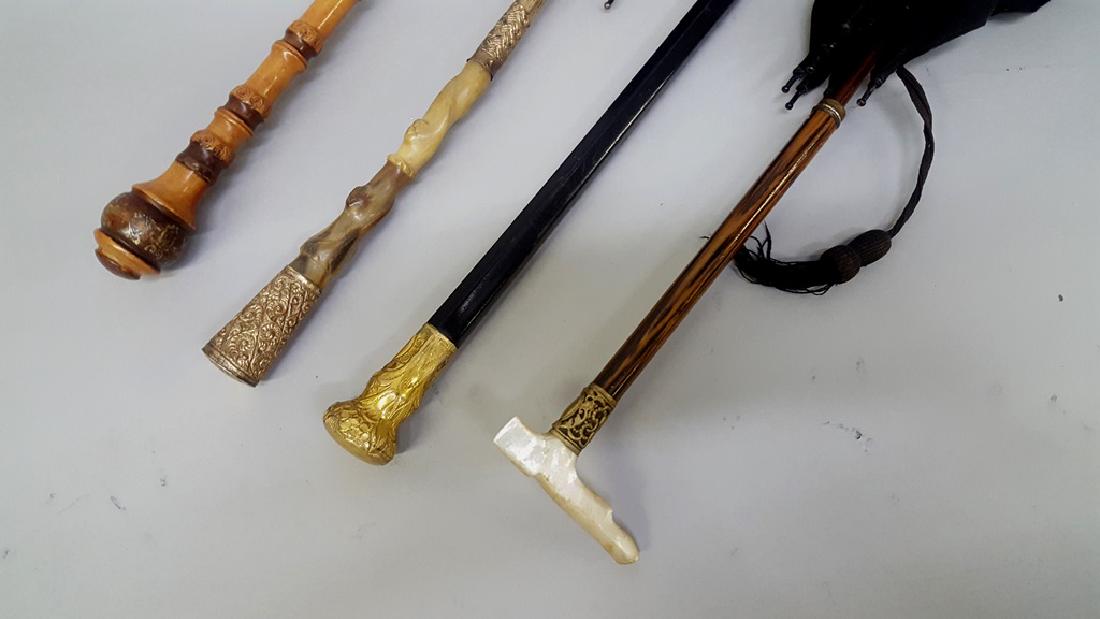Collection of four elegant antique umbrellas - circa: Collection of four elegant antique umbrellas - circa 1900. largest L 41.5" with Gold plate top signed (K&H) 2nd one w/gold plate & carved bone décor L 38.5" 3rd one with metal & mother of pearl d