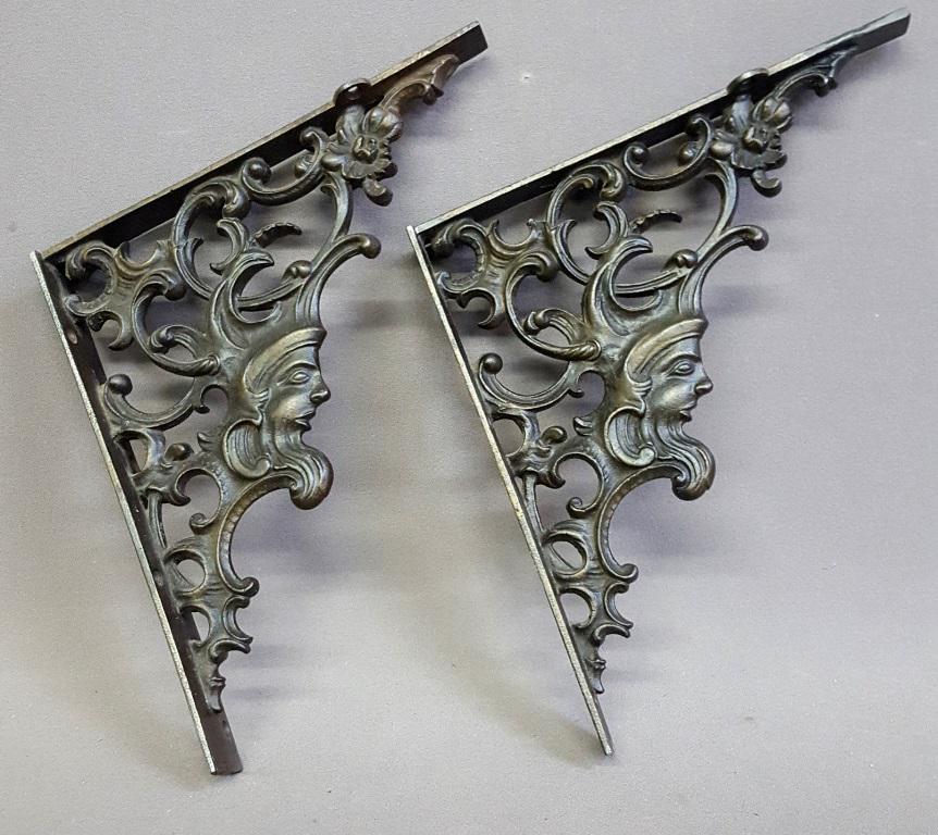 C 1900 Cast Iron Shelf Brackets with Northwind Face -: C 1900 Cast Iron Shelf Brackets with Northwind Face - hgt 13" depth 11.5". Good condition. Found in St Paul MN estate.