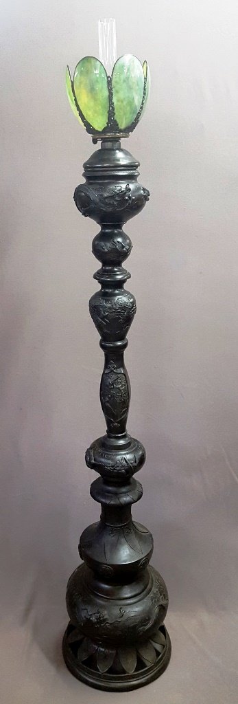 Japanese Bronze Kerosene Lamp, Meiji Period: Japanese Bronze Kerosene Lamp, Meiji Period (1868-1912), lobed standard cast with mythical and genuine creatures, h. 66 in. Antique green slag glass globe. We broke the other globe. Dia. 9"Provenance: