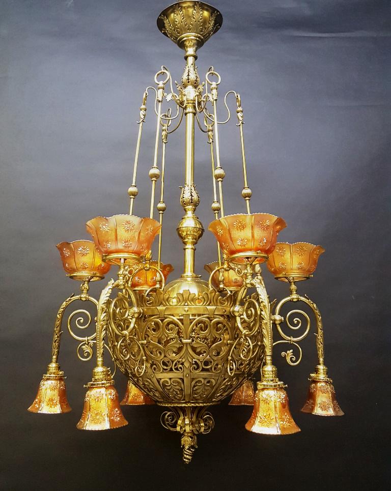 Superb Brass 12 Arm Gas & Electric Chandelier all: Superb Brass 12 Arm Gas & Electric Chandelier all polished & wired ready to be hung. Has 12 antique matching carnival gas & electric shades. All in good condition. Rare fixture. Hgt 55" dia. 35".