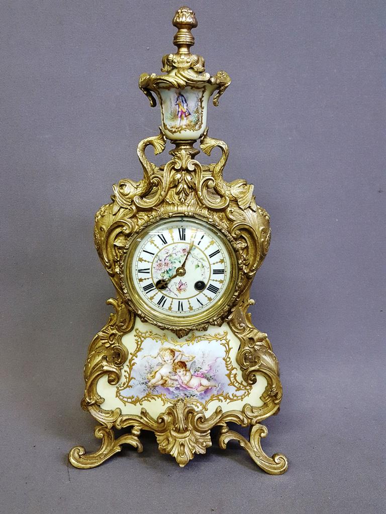 19th Century Bronze & Porcelain Clock (Japy Freres).: 19th Century Bronze & Porcelain Clock (Japy Freres). Hgt 18.75" w9.5" d6". Superb cast bronze clock w/ Dolphin décor. Has butterfly decorated porcelain dial plus cupid & garland porcelain decoration 