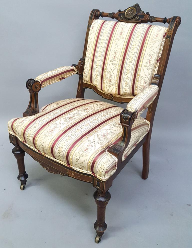 Circa 1870's High Style Victorian Arm Chair with Brass: Circa 1870's High Style Victorian Arm Chair with Brass Plaque in the Back. American made Renaissance revival arm chair with black & gold line décor. Hgt 35"w 22"d 25". I sold this chair 30 years ago.