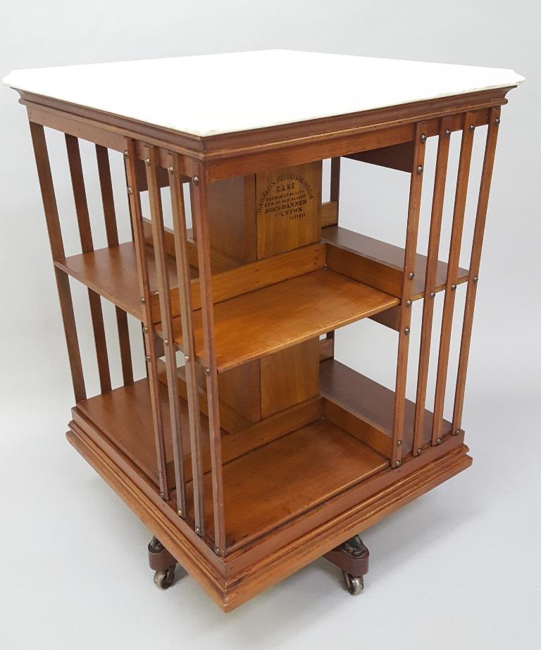 Signed Danners Revolving Bookcase Pat: May 1876.: Signed Danners Revolving Bookcase Pat: May 1876. Unusual walnut with original marble top and finish. Has great original label John Danner Canton Ohio. Hgt 37" w 24" d 24". Found in Winona MN estate.