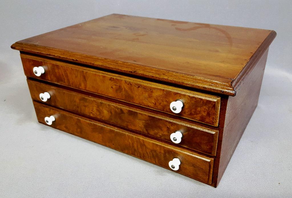 Dated Mar 21,1875, 3 Drawer Walnut Spool Cabinet with: Dated Mar 21,1875, 3 Drawer Walnut Spool Cabinet with original porcelain pulls. W 18.5" d 14.5" h 8.5". Good refinished condition. Found in St Paul MN estate.