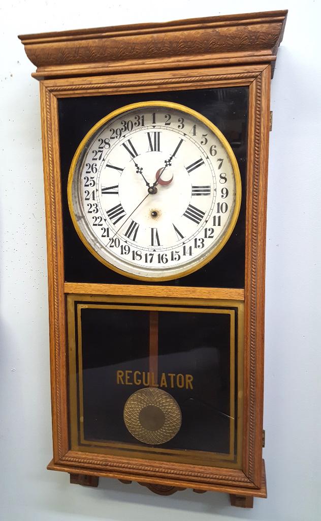 Signed (Sessions) Oak Wall Regulator with calender hand: Signed (Sessions) Oak Wall Regulator with calender hand - has nice carved case, original glass & dial, movement cleaned and running. Circa 1900. Paper Sessions label on the back. Hgt 37" w 18". Key & 