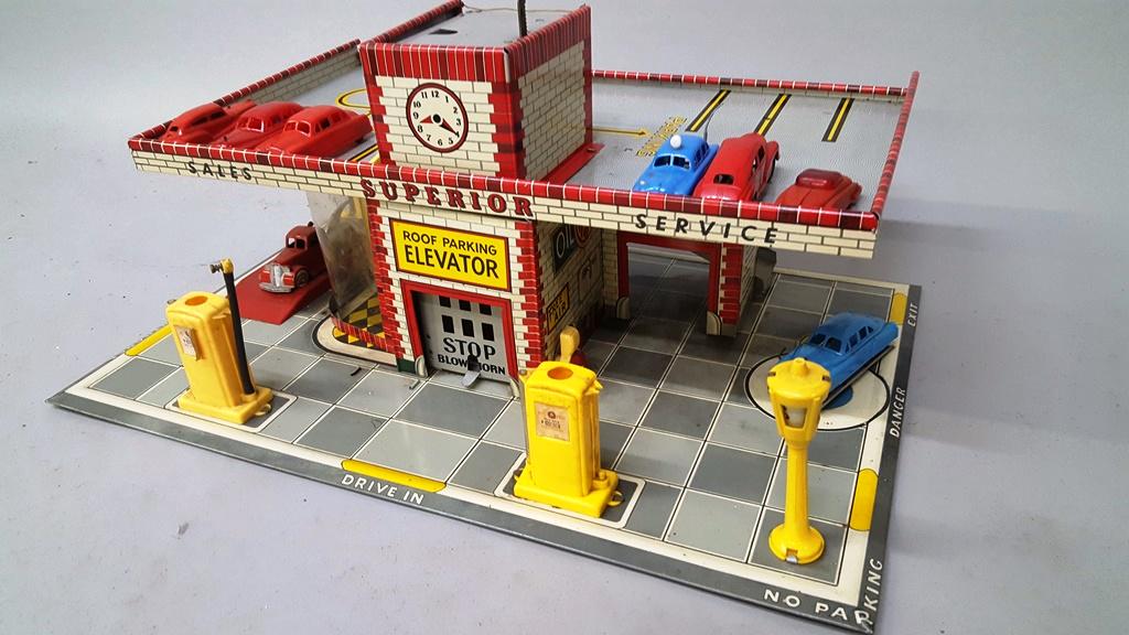 Antique Painted Metal Gas Station with Elevator, Pumps,: Antique Painted Metal Gas Station with Elevator, Pumps, Lobby. Also has 6 cars & a tow truck. Width 25" d 16.5" hgt 12". Very good condition for age.