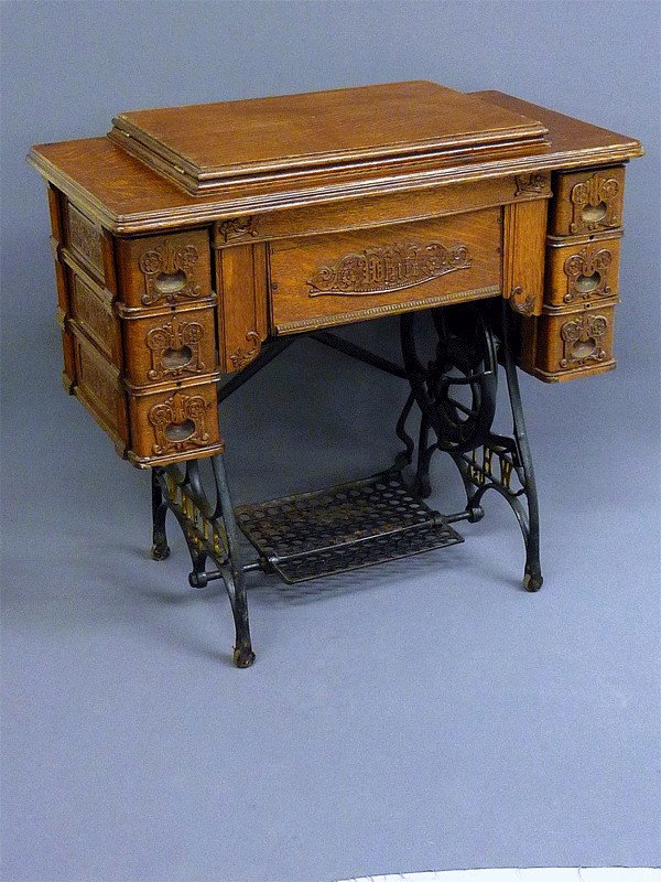 FANCY CARVED OAK SIGNED "WHITE" SEWING MACHINE FRO: FANCY CARVED OAK SIGNED "WHITE" SEWING MACHINE FROM EAU CLAIRE WI EST. -H 31" W 33"CIRCA 1900