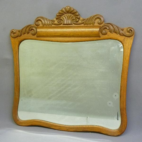 Circa 1900 Oak Bevel Glass Hanging Wall Mirror with carving.  Height 34" width 34". Found in (1 of 1)