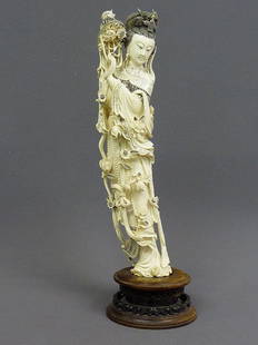 A CHINESE CARVED IVORY FIGURE OF QUAN YIN, Hgt. 22: A CHINESE CARVED IVORY FIGURE OF QUAN YIN, Hgt. 22" ivory 19 1/ 2"- goddess standing in flowing robes, elaborate headdress, w/necklace , holding a bouquet of flowers. 8.2 lbs
