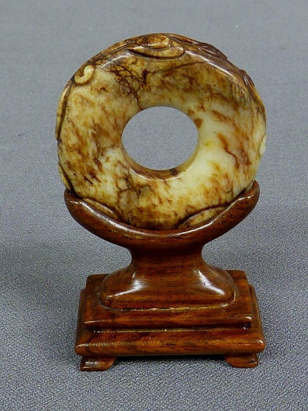 CHINESE BROWN & WHITE JADE CARVED RING ON WOOD STAN: CHINESE BROWN & WHITE JADE CARVED RING ON WOOD STAND - Hgt 3.4" Dia. 2" - good condition