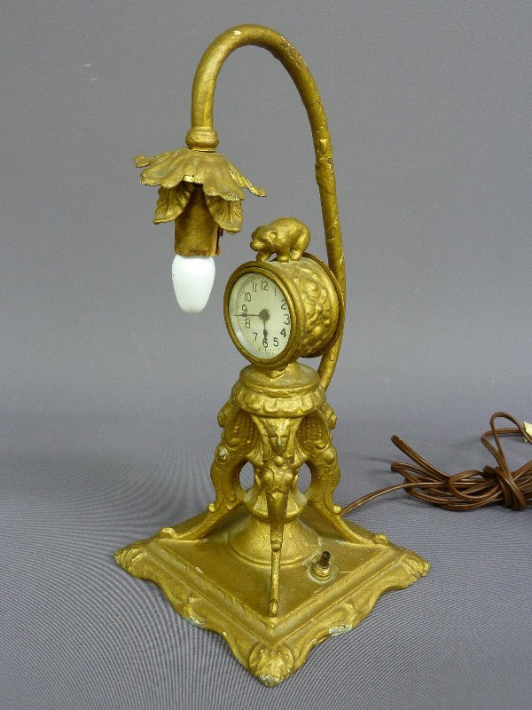 UNIQUE AMERICAN CAST METAL CLOCK with LIGHT ON TOP: UNIQUE AMERICAN CAST METAL CLOCK with LIGHT ON TOP & BEAR ON CLOCK marked (ML CO. dated 1926) Hgt 13 1/2" W 6" - condition seems complete