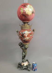 C 1890's Large Putti Decorated Oil Lamp with child holding lamp on marble base with 3 putti faces as: C 1890's Large Putti Decorated Oil Lamp with child holding lamp on marble base with 3 putti faces as feet. Signed (Parker) The finest oil banquet lamp I have ever had. Great condition. Hgt 44" dia.