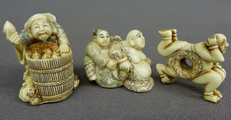 THREE ELEPHANT IVORY NETSUKES, A MAN with BASKET,: THREE ELEPHANT IVORY NETSUKES, A MAN with BASKET, Man & Woman , and 2 Men - heightest 2" widest 2" , two of these signed - all in good condition