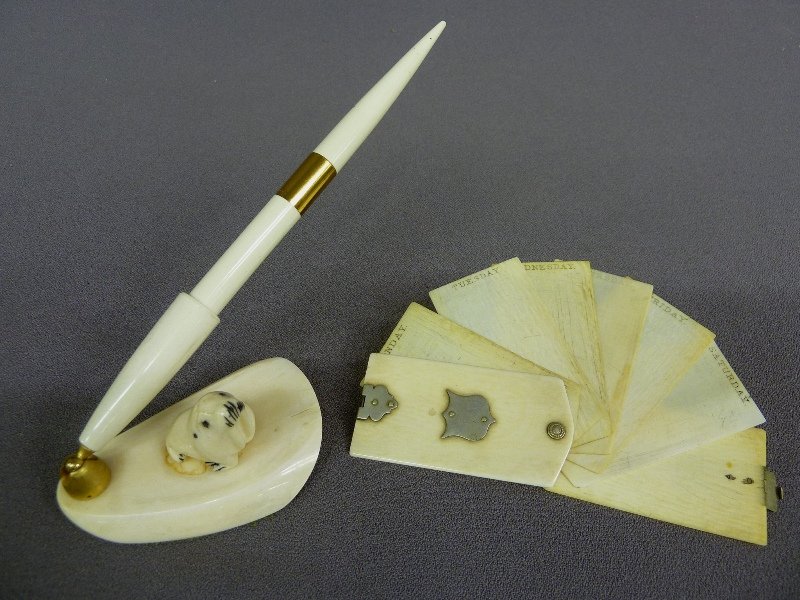 Two pieces of Carved Ivory one Pen holder with sea: Two pieces of Carved Ivory one Pen holder with seal signed ivory H 8" w 3.25" plus a Ivory Monday thru Friday date book with Silver clasp - H 2.75" W 1.4" - good condition