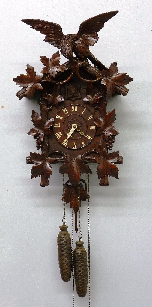 QUALITY HEAVILY CARVED BLACK FOREST, COO COO CLOCK: QUALITY HEAVILY CARVED BLACK FOREST, COO COO CLOCK w. EAGLE CREST, height 25", width 14", Circa 1920's- good condition