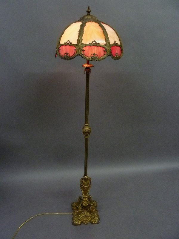 Circa 1920's Carmel Slag Glass and Red Ornate Floor: Circa 1920's Carmel Slag Glass and Red Ornate Floor Lamp signed (Mosaic Shade Co. Chicago ILL. - 16 panels in lamp - 4 winged griffins around the base.- height 62" dia. 16"- good old finish and condit