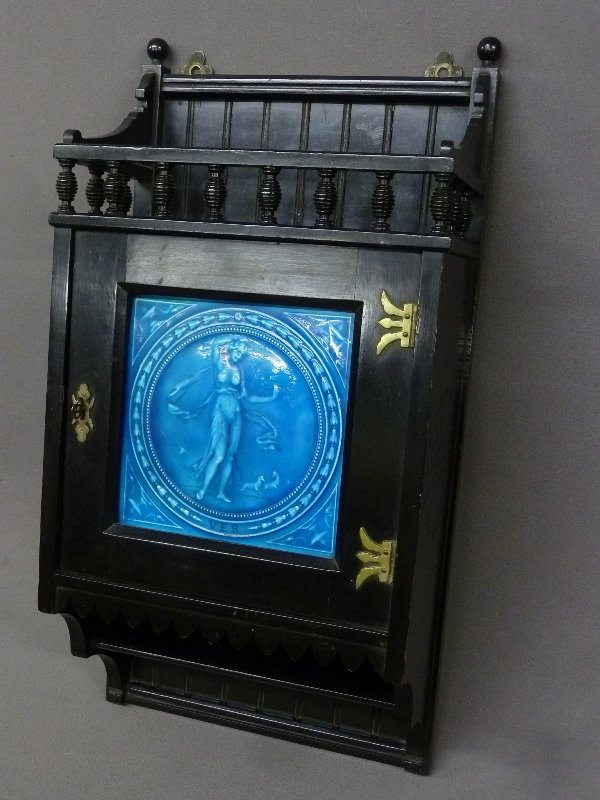 Unique Circa 1880 Ebonized Wood Wall Cabinet with: Unique Circa 1880 Ebonized Wood Wall Cabinet with Signed Minton Hollins & Co. glazed tile depicting a Goddess - marked Tile Works Stoke On Trent - height 27" width 13.5" depth 7" - good original finis