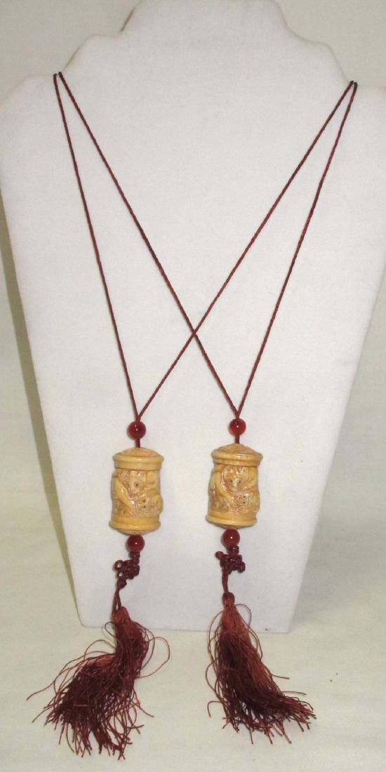 2 Carved Ox Bone Inris: 1 1/2" carvings, 26" ties