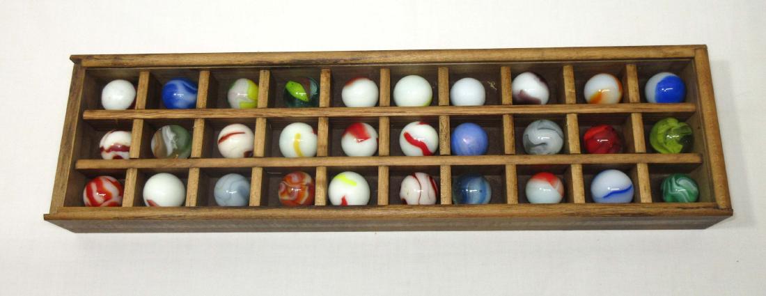 30 Nice Shooter Marbles: With wood display case. Case is 1 3/4" x 15 1/8" x 4"