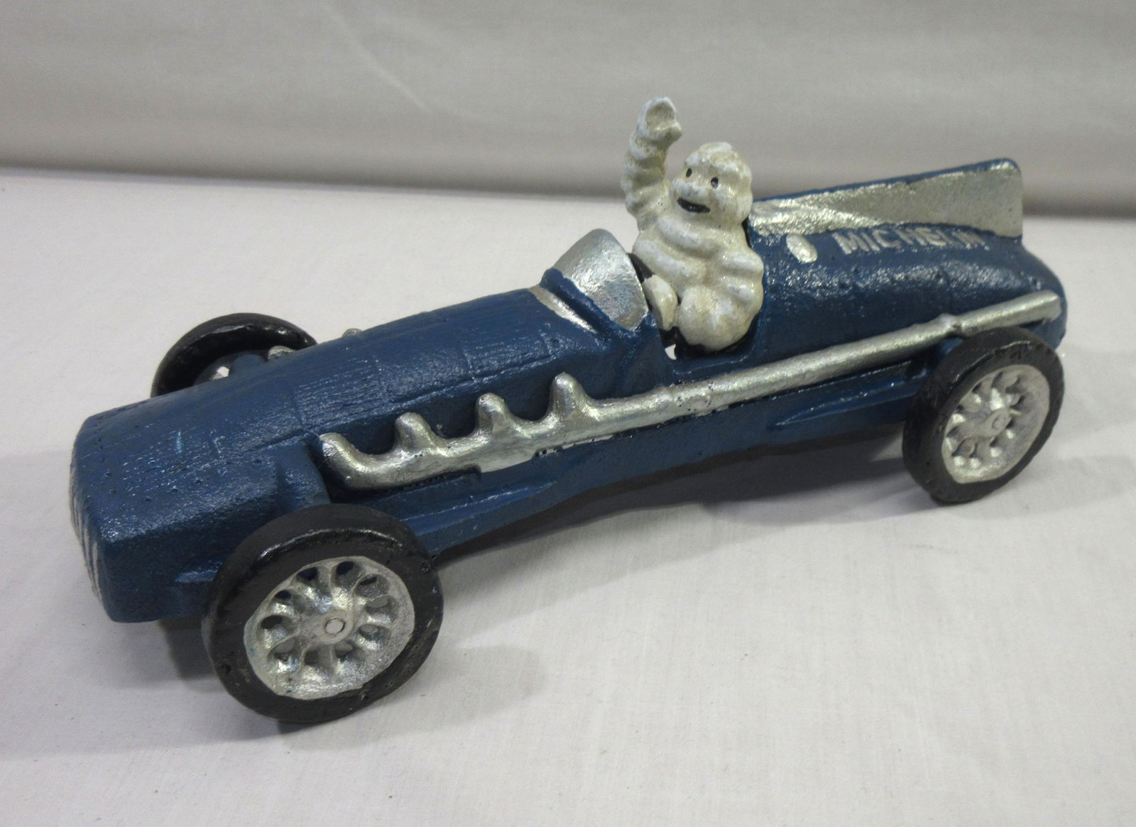 Modern Cast Iron Michelin Man Racer Toy: 3 3/4"T x 10" x 4"W