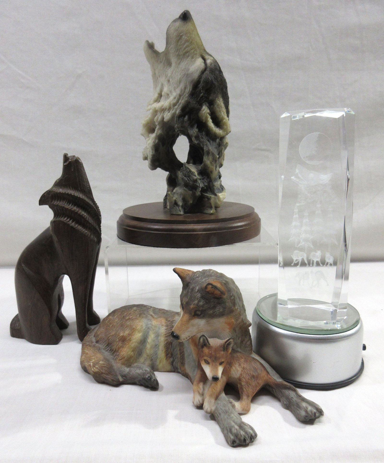 4 Wolf Figures: 8"T crystal has lighted base needs batteries, 7" wood wolf, 8" sculpture, 8" ceramic w/ babies