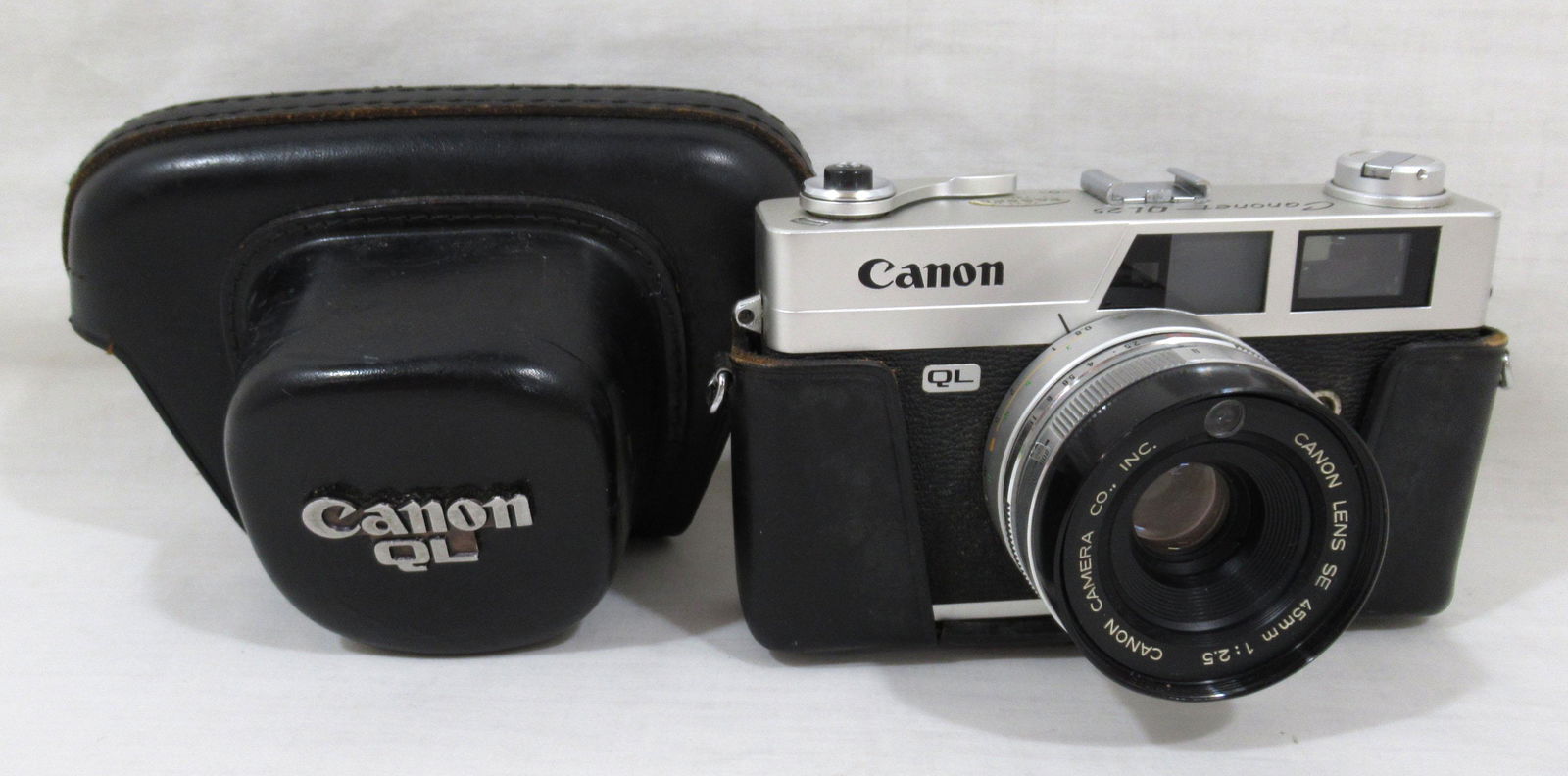 Canon Canonet QL 25 Rangefinder Camera: Canon SE 45mm 1:2.5 lens. QL is "quick load" feature. Comes with black leather case