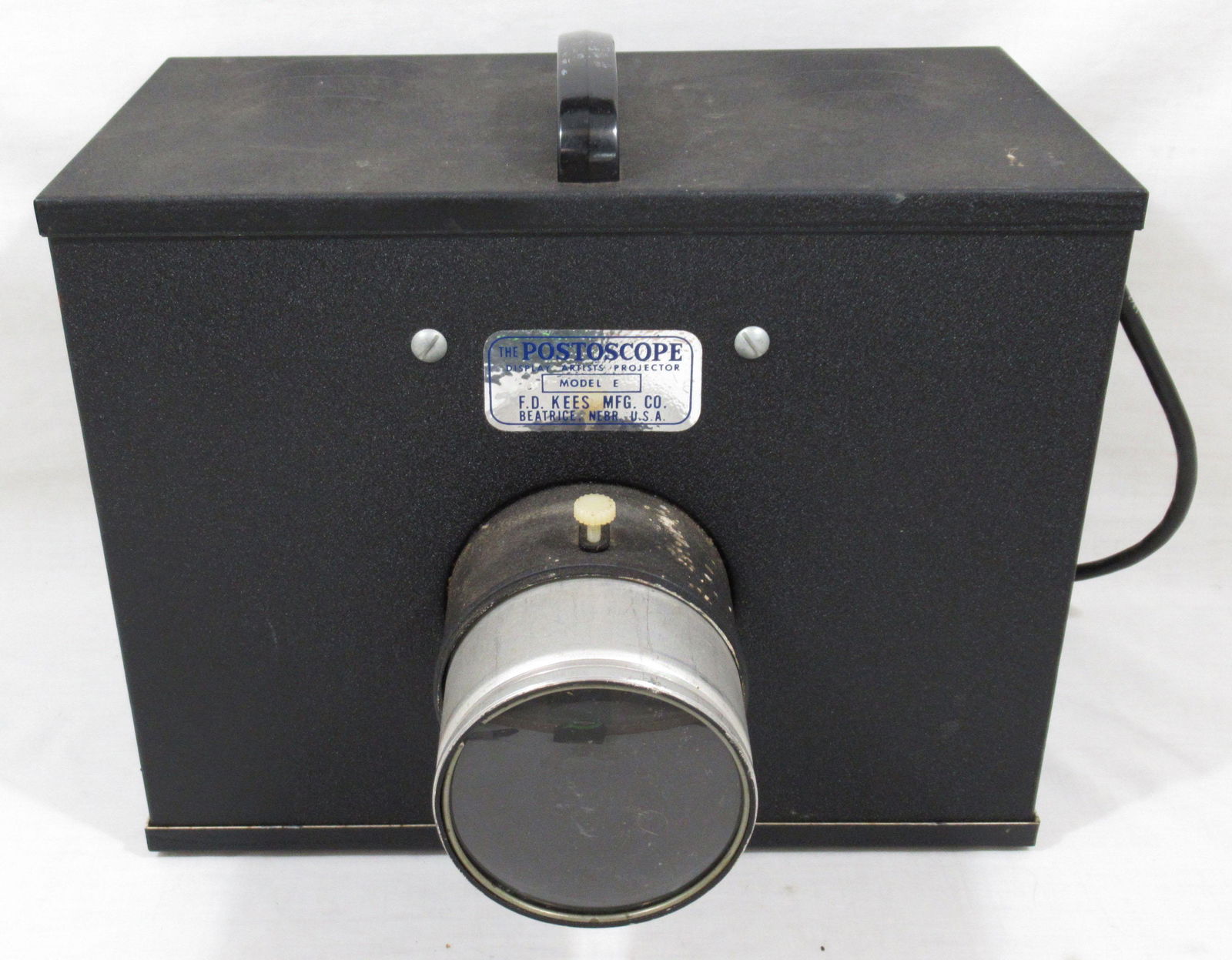 Model E Postoscope Display Artists Projector: Ed Kees manufacturing, Beatrice, Nebraska. Projects image on wall from opaque sources such as books, prints, photos, drawings, etc. All metal construction.