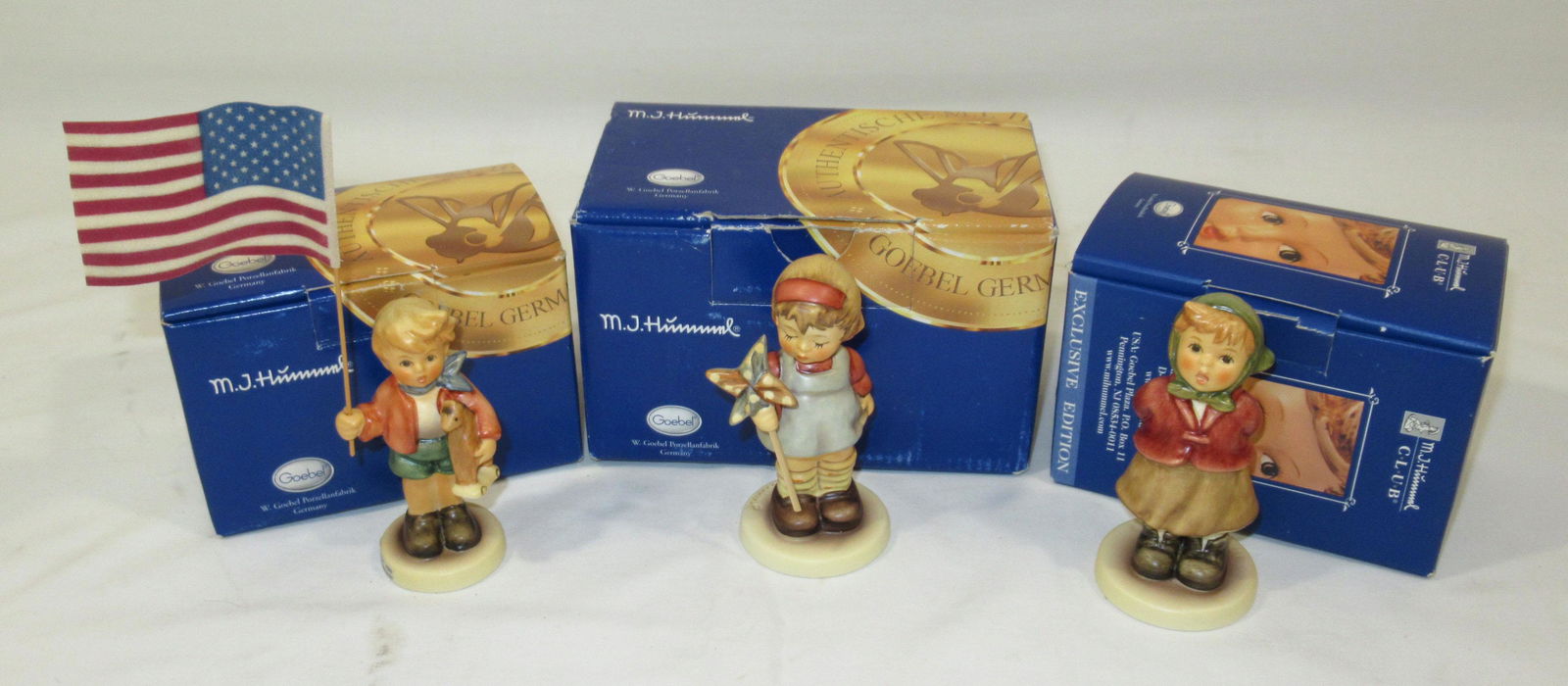 3 Hummels in Orig. Boxes: "Clear As A Bell" 3 3/4"T, "Little Flag Bearer" 3 1/2"T not inc flag, "All By Myself" 3 3/4"T