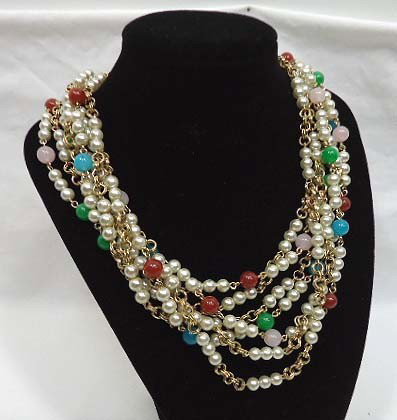 7 Strand Necklace: 7 Strand necklace with faux pearls, lucite colored beads, gold chain & rhinestones with ornate clasp. Fabulous necklace !!!