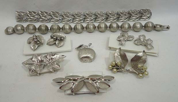 8 Pc. Crown Trifari Brushed Silver Lot: 8 Pc. Of Crown Trifari brushed silver jewelry to inc. 2 bracelets 7" to 8", an apple pin and 5 pr. Of earrings.