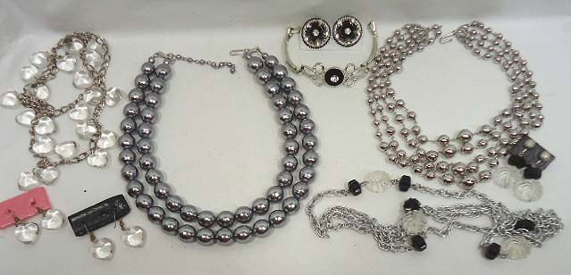 New Year's Eve Jewelry Lot: Includes a 46" Sarah Cov. Silver and black and clear necklace, a 28 1/2" Clear lucite hearts on silver chain necklace & earring set, 7" bracelet and earring set, silverton rhinestone & black 4 strand 