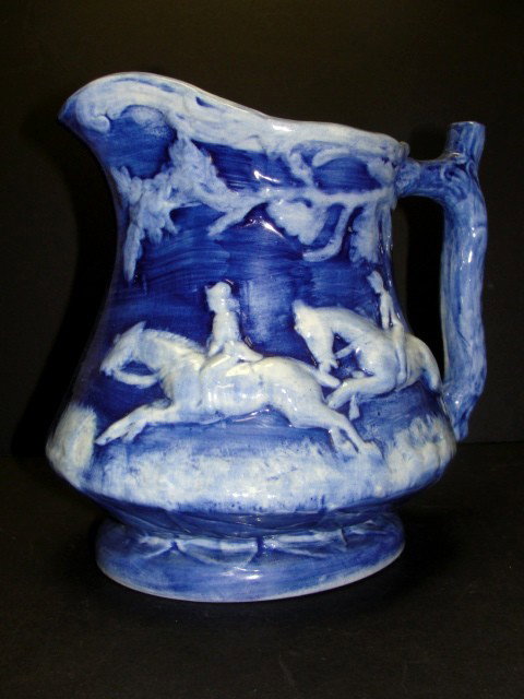Blue & White Pitcher Clinchfield Artware Pottery: depicting a hunt scene in a high glazed finish. The bottom of the pitcher is marked "CLITCHFIELD ARTWARE HAND PAINTED ERWIN TENN." made by the cash family. Condition very good. Ray and Pauline Cash op