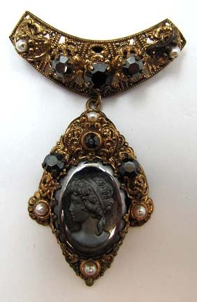 Vtg Hematite Cameo and Brass Filigree Brooch: 2 3/4" Drop Pendant Hematite Cameo w/ Hematite Chaton's & Faux Pearls in Brass Filigree Frame.