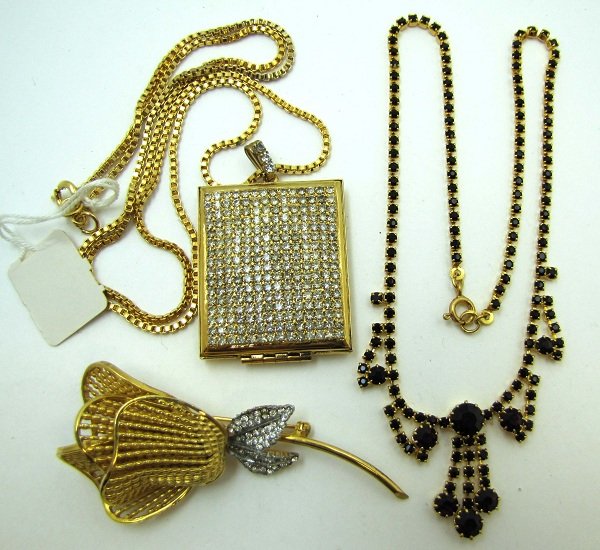 3 Pc. Vtg Goldtone & Rhinestone Jewelry: Inc. 16 1/2" Ruby Red Prong Set Chaton Choker. 28" New/Old Stock Goldtone Chain w/ 2 1/4" Pave Set Rhinestone Locket. & 3" Textured Goldtone Flower Brooch w/ Pave Set Rhinestone's. All Goldtone