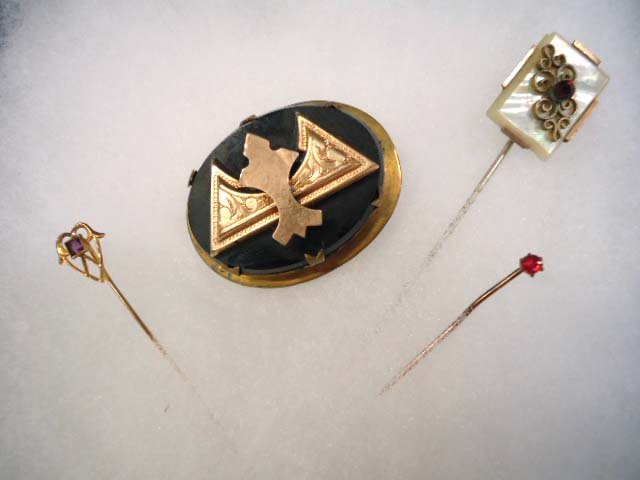 Victorian Brooch, 10Kt Gold Hat Pin & More: 1 6/8" Layered Black Glass Victorian Brooch 1/2" Deep, Nice. 2 1/4" 10Kt Gold Stick Pin w/ Amethyst Stone, .71g. 3 1/8" MOP & Ruby Glass Stone Hat Pin. 1 1/2" Stick Pin w/ prong set Red Stone.