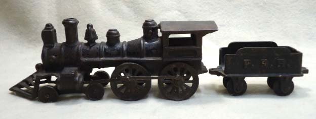 C.I. Train Engine and Tender: 9 1/2"L x 4"T Missing one wheel up front. Has Tender 4 1/2" x 2 1/2"