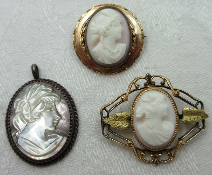 3 Victorian Cameo's: Inc. 7/8" Deeply Carved Cameo w/ Ext. Pin, 1 1/4" x 1 1/16" Pink Cameo w/ Gold Openwork Setting w/ Ext. Pin. & 1 1/4" Abalone Cameo Pendant