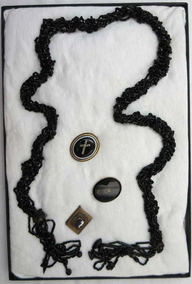 4 pc. Victorian Black Glass Jewelry: Inc. 37" Braided,Tassled Blk Glass Seed Bead Necklace, 1 3/8" Vict. Onyx Cab Set in Black & Gold Un-Marked Setting w/Rhin. Cross. 1 5/16" Onyx Vict. Pin, Blk & White Cameo on Carnelian Bass Locket.
