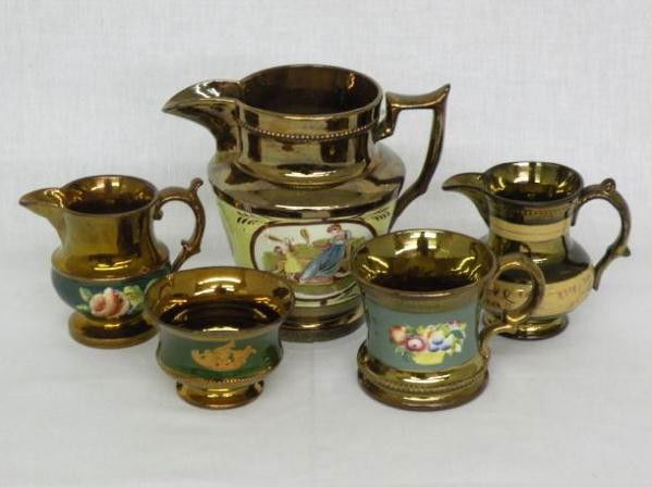 5 pieces of copper lustre: all ca. 1840-1860, pitcher with yellow band & transfers of woman winding yarn & child playing badminton; creamer with brown floral band; small bowl with green band & raised sail boat; creamer with gre