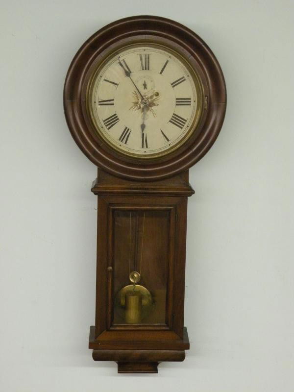New Haven Office No. 1 wall clock: ca. 1880, weight driven regulator in a mahogany case with painted metal dial, brass bezel, 8 day time weight driven time only movement, cast iron mounting bracket, 41";