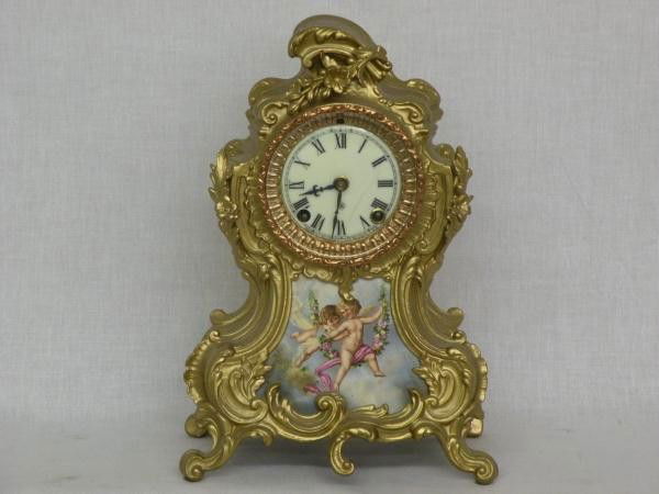 Ansonia mantel clock: ca. 1880, metal & porcelain case, French style, cast brass bezel, beveled glass, 8 day time & strike spring driven movement, 12"x 8 ½"x 5";