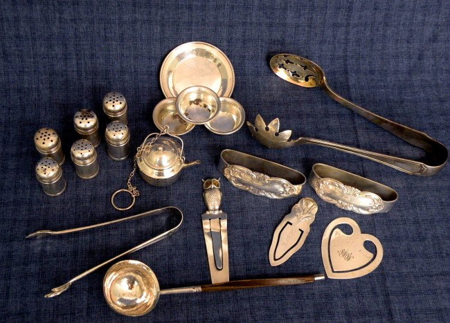 19 pcs. sterling silver: ca. 1940-60; 3 bookmarks; pair of napkin rings, repusse rose pattern; tea kettle form teaball; 6 individual salt & peppers; claw sugar tongs; food serving tongs; butter pat; 3 individual salts; small 