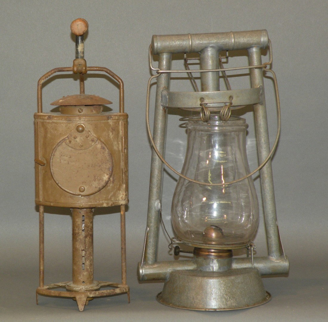 2 lighting devices: ca. 1870-1910; signal lantern with reflector, red lens & painted surface, 4 ¾"x 4 ¼"x 15"; Hermance tilt globe action tubular lamp with glass globe, 7 ½"x 5 ¾"x 13 ½";