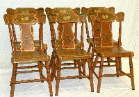 Set of 6 signed fiddle back plank bottom chairs: ca. 1850-70; paint decorated with pumpkin ground, floral decoration & 1 chair with the business card of the maker "Jas. H. Barnes.. chair maker No.8 East King St., Lancaster, PA", 15 ½"x 20"x 32";